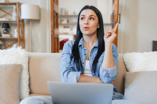 Eureka, woman and laptop on sofa at home for solution, idea and creative inspiration. Living room, freelancer and computer for remote work, planning and problem solving concept