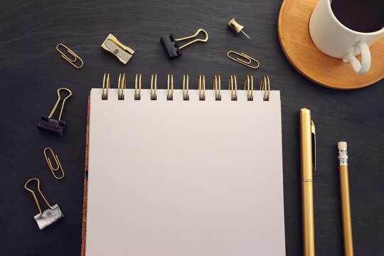 Top view image of table with coffee and office supplies