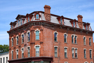 Old office building in the Romanesque Revival style of architecture, with mansard roof and dormer windows © Spiroview Inc.