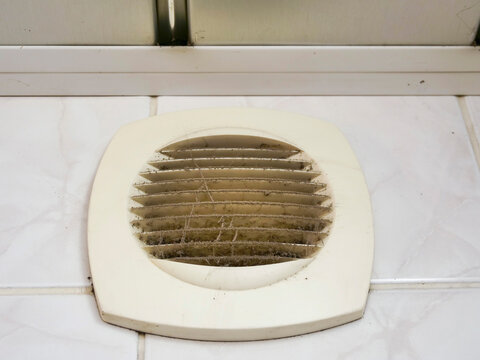Dirty air vent with dust and cobwebs. Ventilation system needs cleaning. Grates covered in debris and filth. Dusty and neglected home or building feature. Not clean or maintained