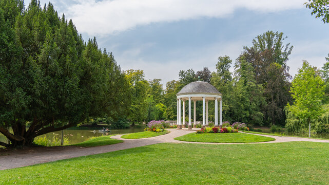 White pavilion for special occasions, celebrations, and wedding ceremonies in a blooming garden, a round, shaded shelter in the Parc de l'Orangerie in Strasbourg, France.