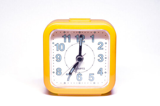 Yellow Retro Alarm Clock Showing 07:00 Time Isolated on Background Vintage Timepiece