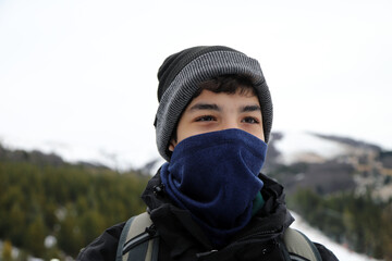 Portrait of a teenager in winter clothing at a ski resort