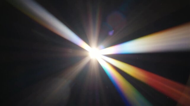 Prismatic light leak with anamorphic flare and rainbow refraction moving across dark space.