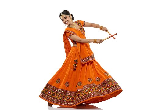 Indian woman dancing garba with dandiya sticks isolated on white background