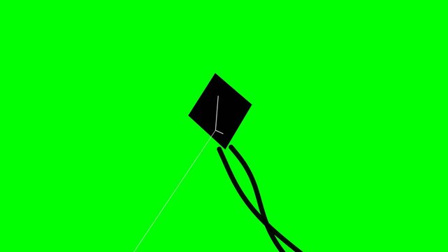 A black kite flying against a vibrant green screen background.