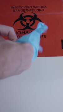 Inspector in lab coat and gloves placing eggs in red biohazard bag, representing Salmonella outbreaks, food recalls, and factory farming safety risks