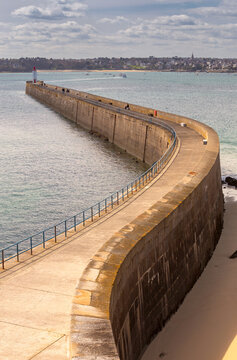 Curved Breakwater and Lighthouse in Saint Malo Harbor France