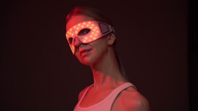 Red and infrared light therapy eye mask. smiling woman wearing infrared light eyes therapy mask. professional biohacker theme skin care video footage