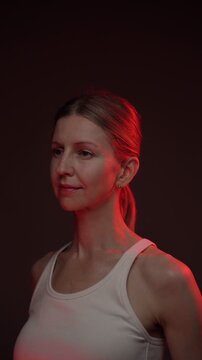 woman portrait in black background with red light. studio shoot. video footage