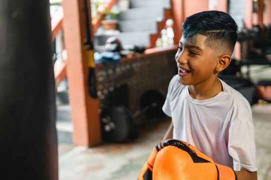 Young boy learning boxing in a gym