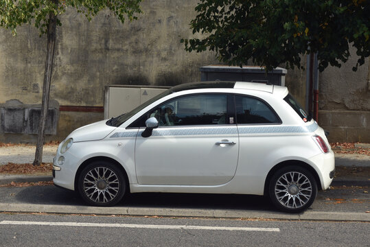 St - Amand Montrond - France - 3 august 2026 - Side view of a white Fiat 500 parked on a quiet street in France. Editorial image featuring the iconic Italian city car.