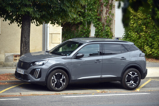 St - Amand Montrond - France - 3 august 2026 - Side view of a grey Peugeot 2008 compact SUV parked on a street, showing a modern French vehicle in an urban environment.
