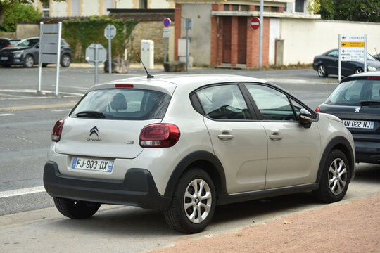 St - Amand Montrond - France - 3 august 2026 - Rear three-quarter view of a beige Citro&euml;n C3 parked on a quiet street 
