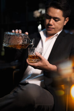 Closeup businessmen holding a glass of whiskey