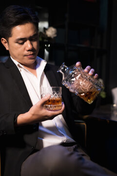 Closeup businessmen holding a glass of whiskey