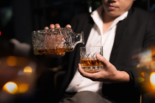 Closeup businessmen holding a glass of whiskey