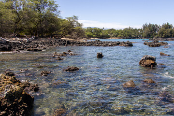 Crystal clear turquoise water over volcanic lava rocks along the coastline of the Big Island Hawaii © Joao Vieira