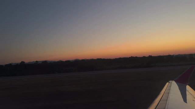 Sunrise View From Airplane Window Over Runway