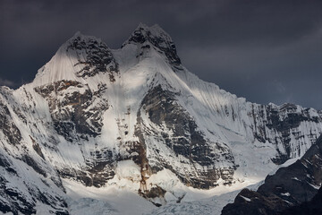 Obraz premium Jirishanca's razor-sharp granite and ice spires pierce a flawless Andean sky in Peru's remote Cordillera Huayhuash, one of the most dramatic and least-visited mountain ranges on Earth. 