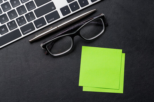 Office supplies on dark leather desk