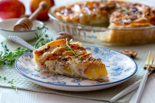 Piece of pie with nectarines and camembert.