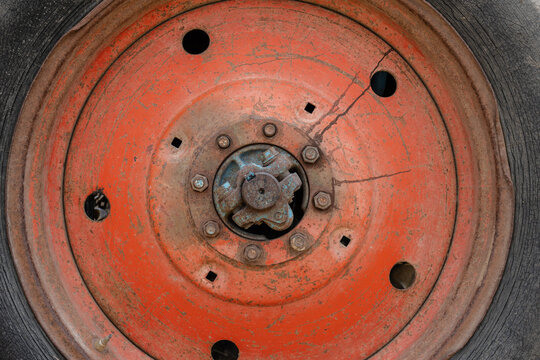 Old tractor wheel showing rusty hub and worn tire