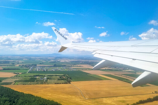 London, United Kingdom, July 10, 2026: Aerial View of Scenic Countryside Below Aircraft Wing on a Clear Day