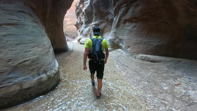 Male Hiker Walking Through the Virgin River in The Narrows, Zion National Park