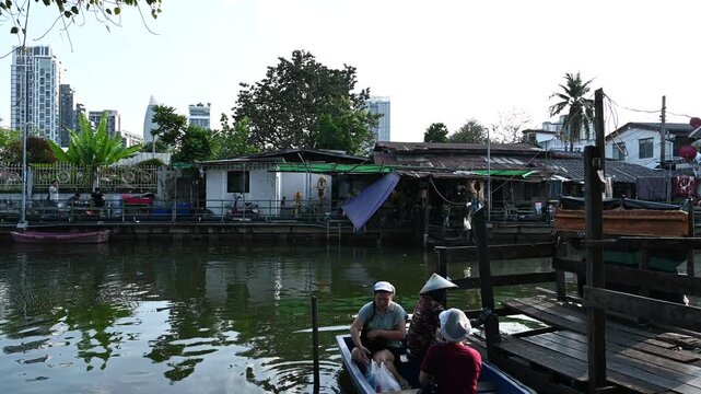 Women board canal boat in Chatumit Village