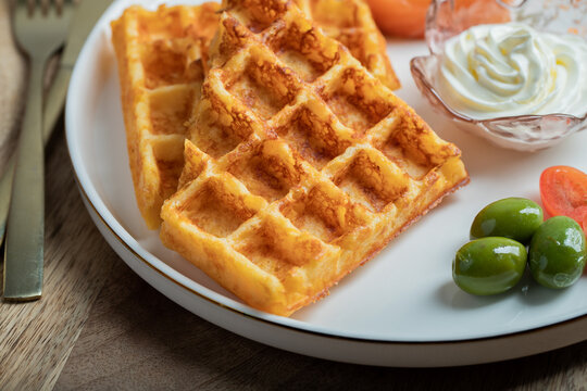 Crunchy waffle fries with sour cream dip served in a basket