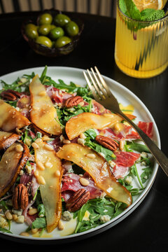Salad with Pear, Arugula, Jamon, Blue Cheese and Blueberry, Delicious Fresh Salad Appetizer on Bright Background