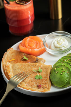 Roasted thin pancakes with smoked salmon and sauce