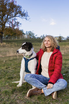 happy woman with dog enjoying autumn outdoors