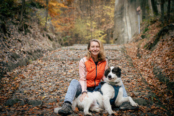 Obraz premium woman and dog enjoying beautiful autumn outdoors