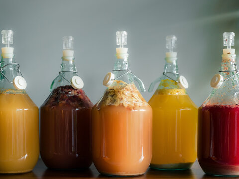 Brewing Different Types of Mead in Glass Jars on a Wooden Shelf