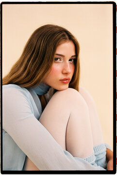 Woman sitting with knees up