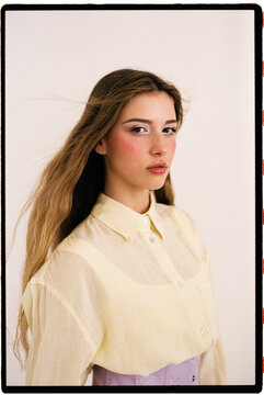 Woman looking at camera with yellow shirt