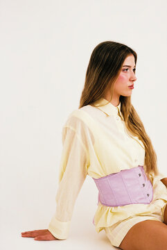Woman modeling corset fashion in pastel colors