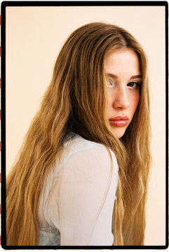 Woman with long blonde hair gazing back