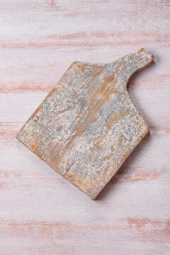 A square wooden cutting board for home food preparation. A wooden cutting board