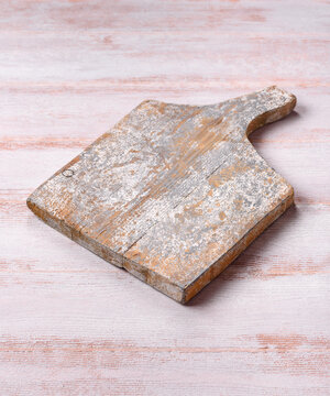 A square wooden cutting board for home food preparation. A wooden cutting board