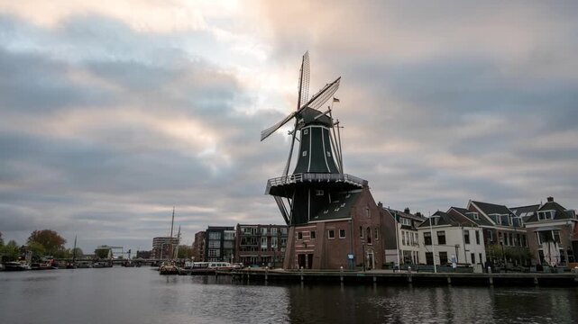 Haarlem Netherlands time lapse city skyline at Windmill Adriaan and canal waterfront