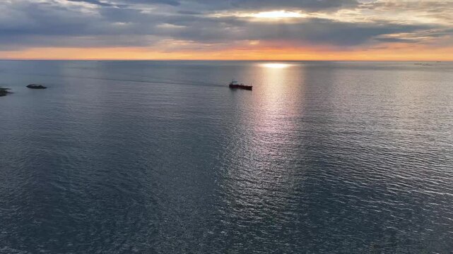 Aerial view of the tanker vessel Key Marmara as it approaches the port of Kristiansund, Norway, at sunset.