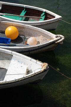 Rowing boats in Mevagissey Harbour Cornwall