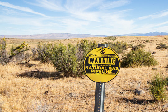 Warning sign for a high pressure natural gas pipeline in the high desert landscape of northern Lassen County, California.