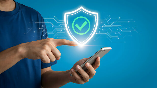Digital Security for Mobile Hand Interacting with Glowing Shield Icon Above Smartphone, Symbolizing Data Protection, Online Privacy, and Cyber Safety