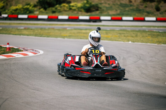 High speed go-kart cornering with a teenage driver on an outdoor track