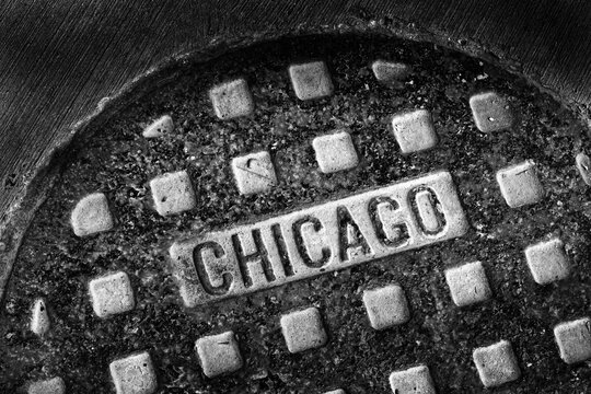 Old Manhole Cover in Chicago City on Street with Texture Worn and Weathered