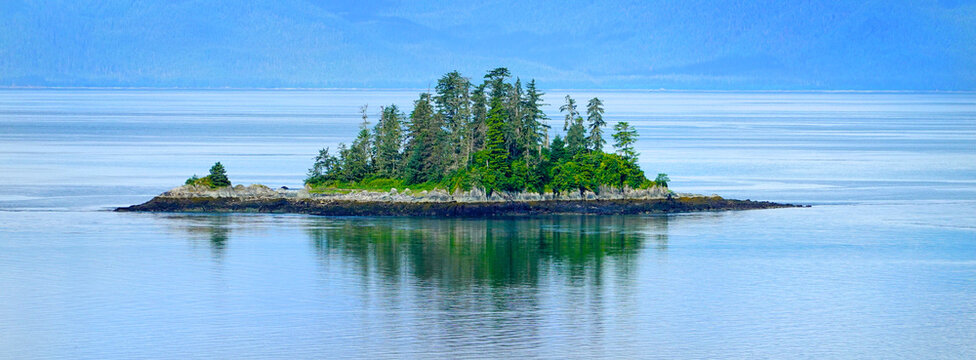 Small Lush Green Islands Covered in Pine Trees Alaskan Wilderness Inside Passage on Ocean